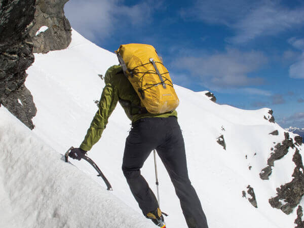 Bergsteiger im Schneefeld - Leichtes Gepäck zahlt sich aus.